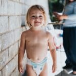 a child standing by a wall